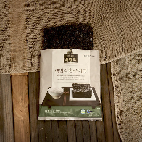 Master Park Hyang-hee’s Stone-Grilled Laver, carefully roasted sheet by sheet over heated stone.